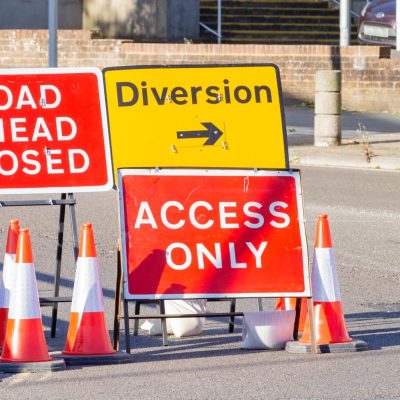 Red and Yellow Road Signs Indicating a Road Closure and Diversion
