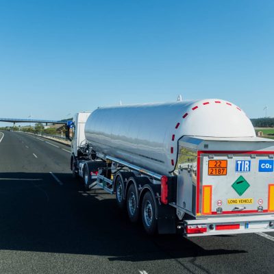 Carbon Dioxide Tanker Truck with Hazard Labels Driving on Highway,TIR transport.